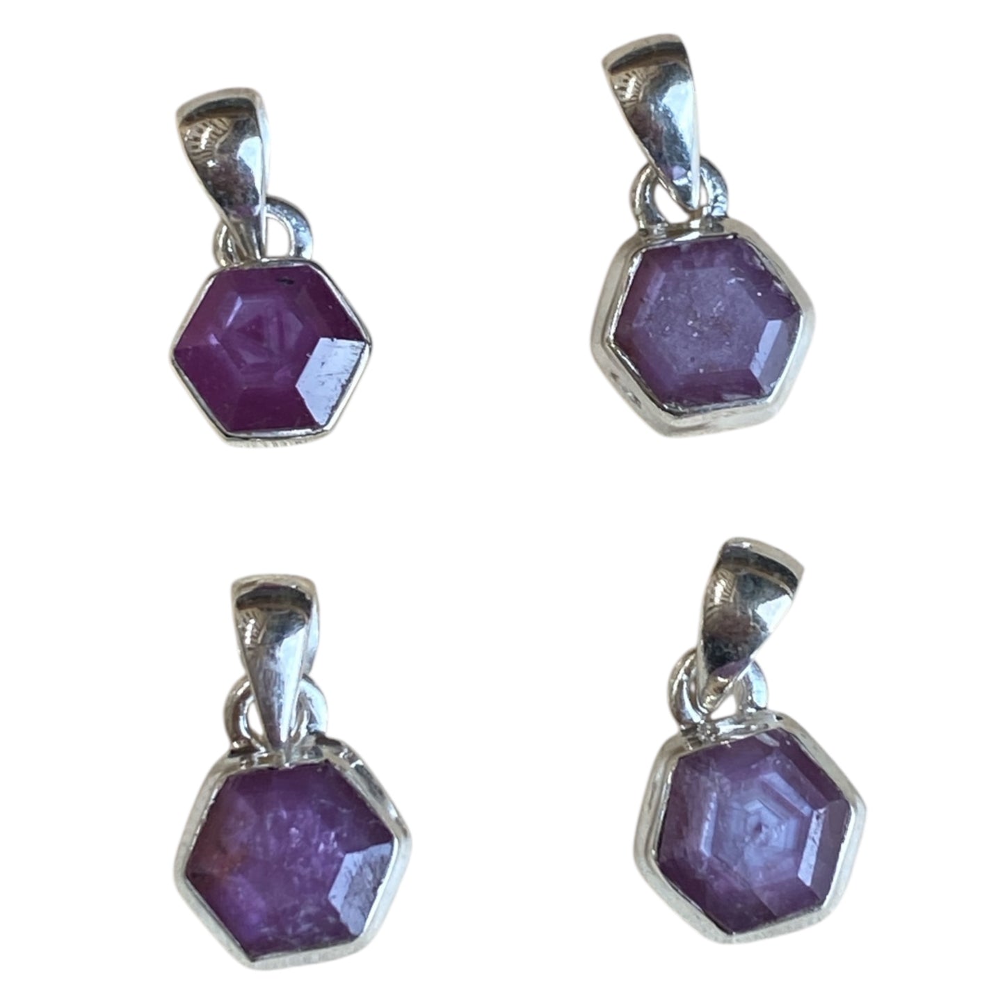 Ruby star sterling silver pendants in claw and bezel settings