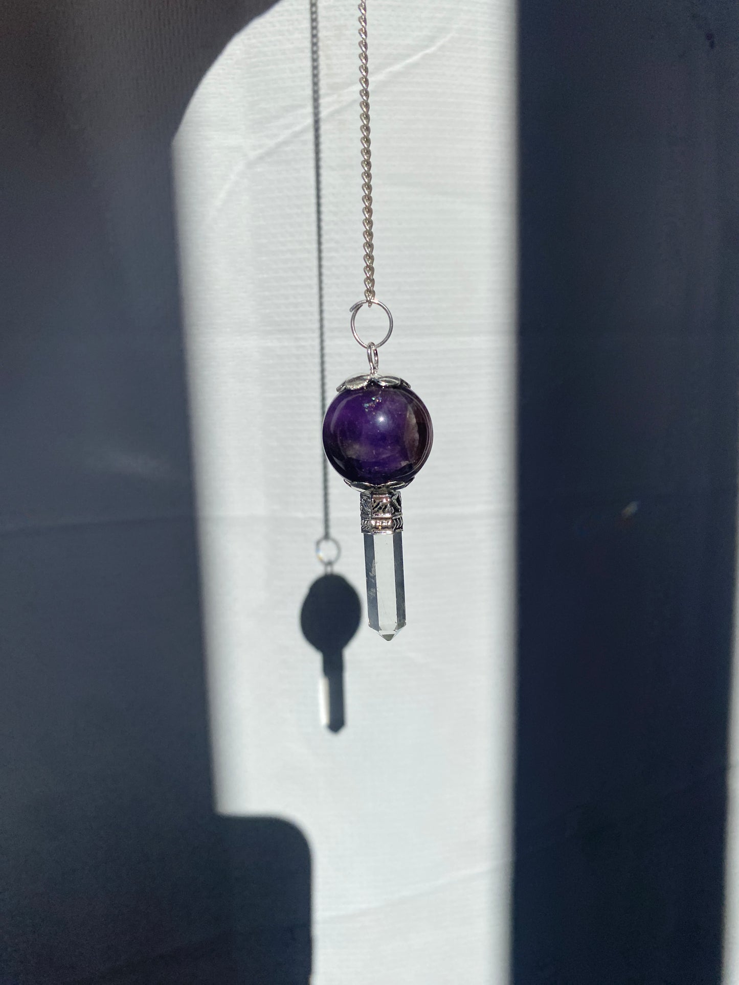 Amethyst pendulum with quartz point