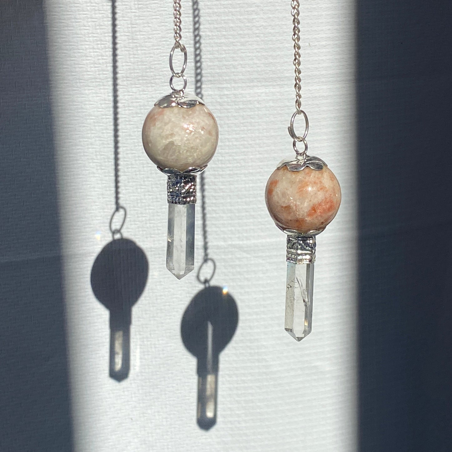 Sun stone pendulum with quartz point