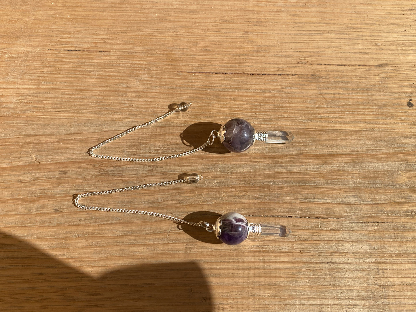 Amethyst pendulum with quartz point