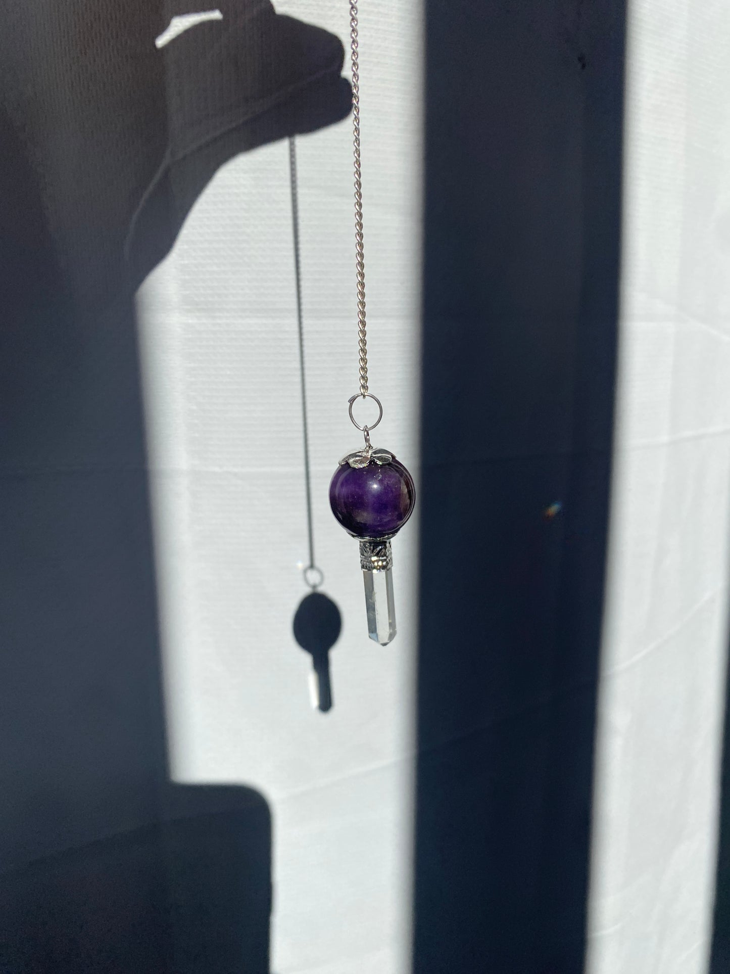 Amethyst pendulum with quartz point