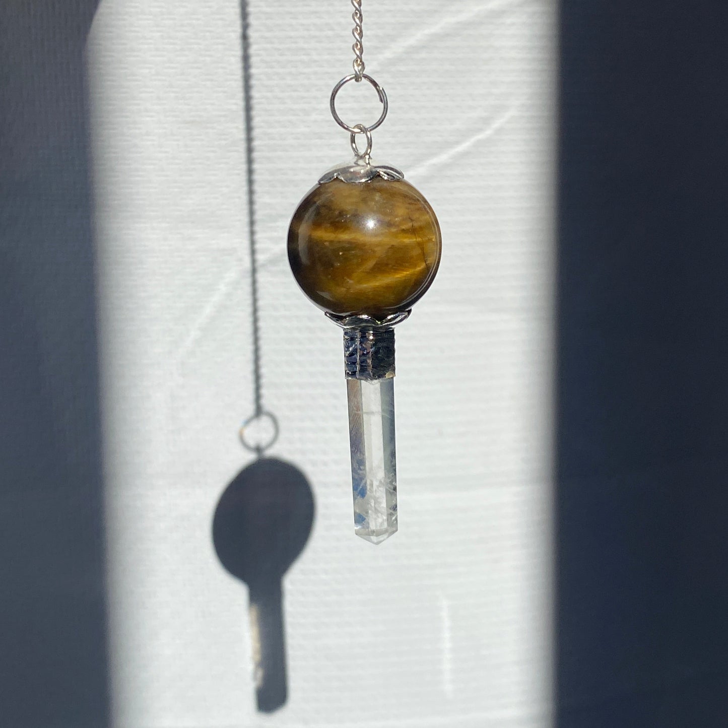 Tiger Eye pendulum with quartz point