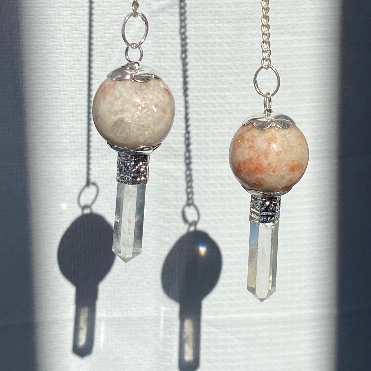 Sun stone pendulum with quartz point