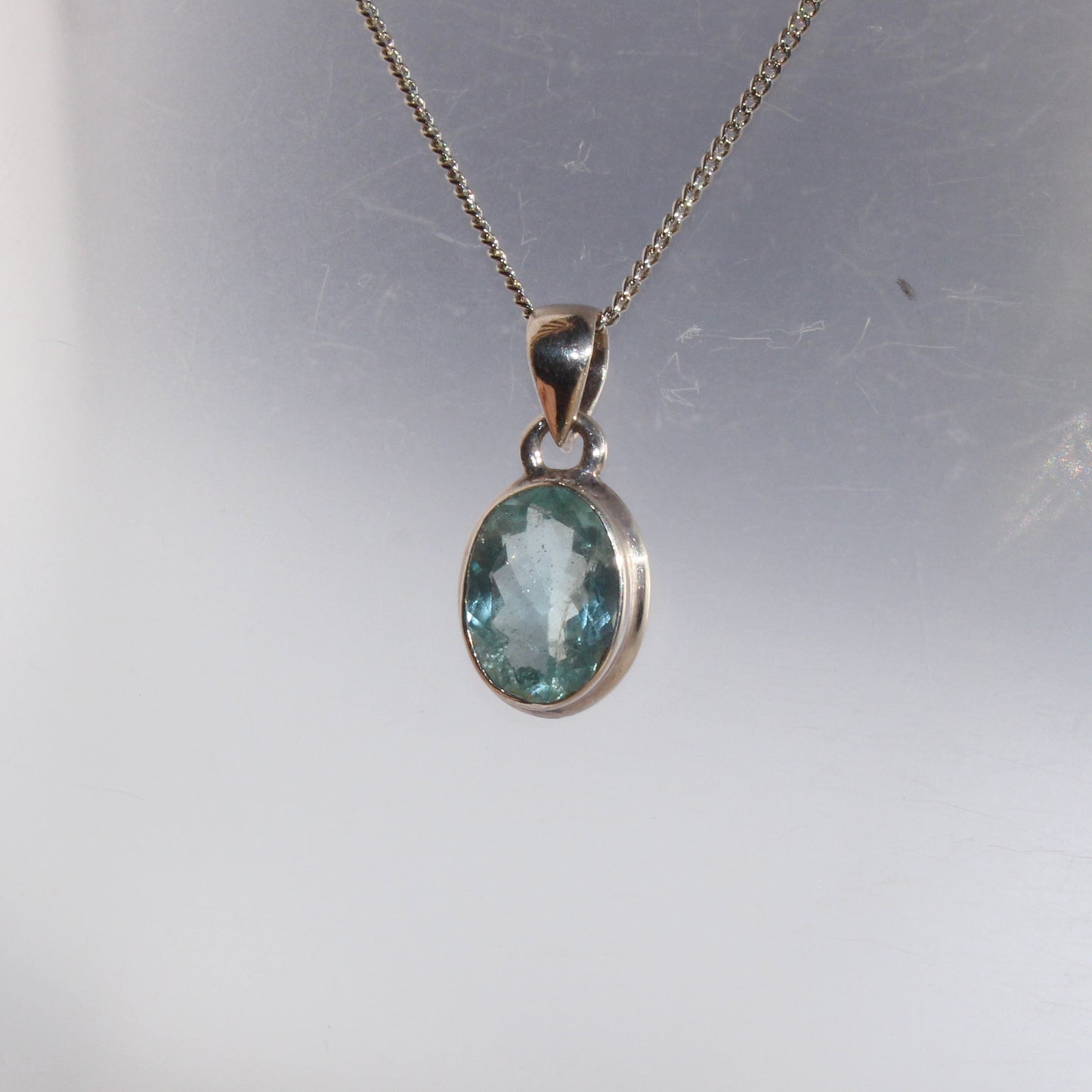 Aqua marine faceted pendant set in sterling silver