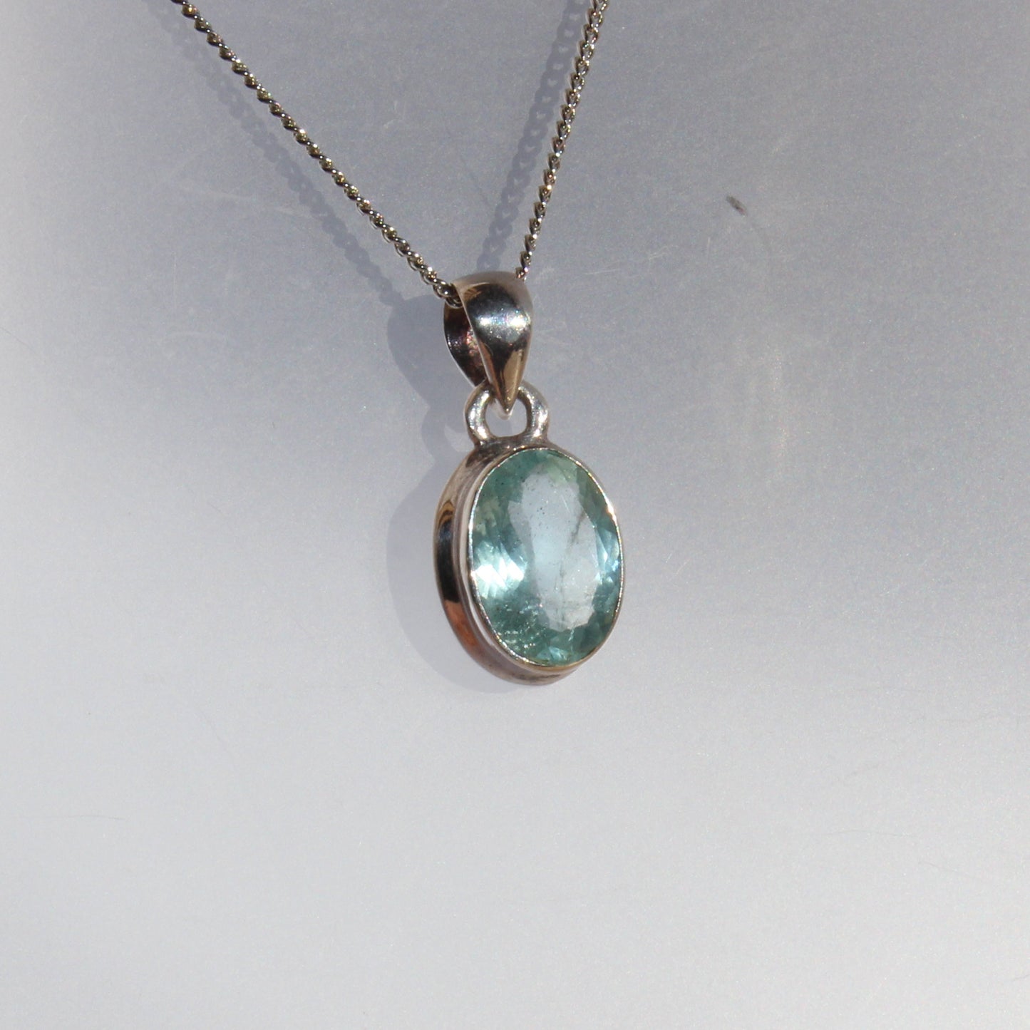 Aqua marine faceted pendant set in sterling silver