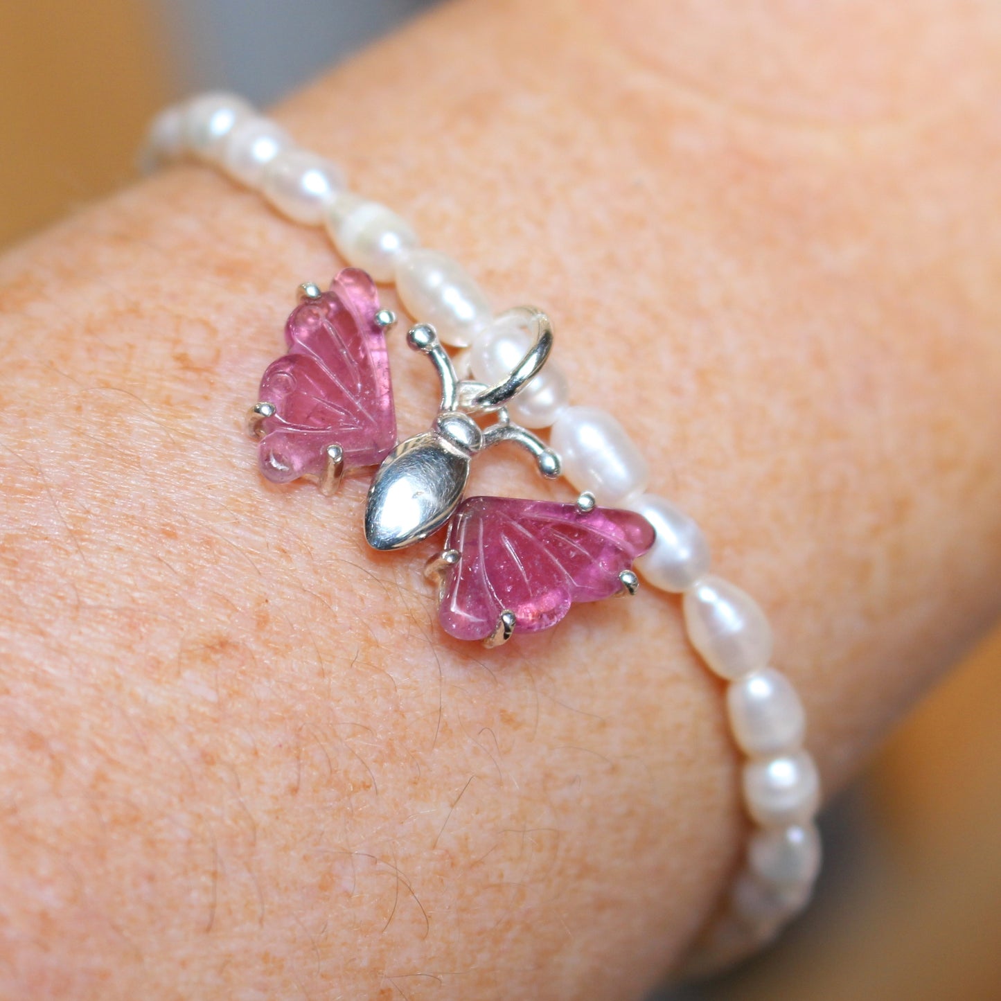 Seed pearl bracelet with pink tourmaline butterfly set in sterling silver