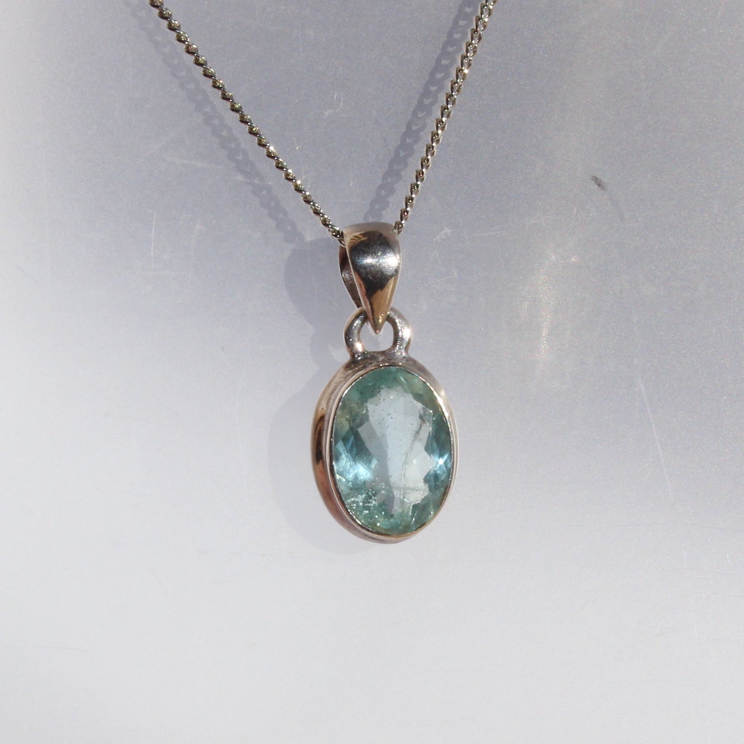 Aqua marine faceted pendant set in sterling silver